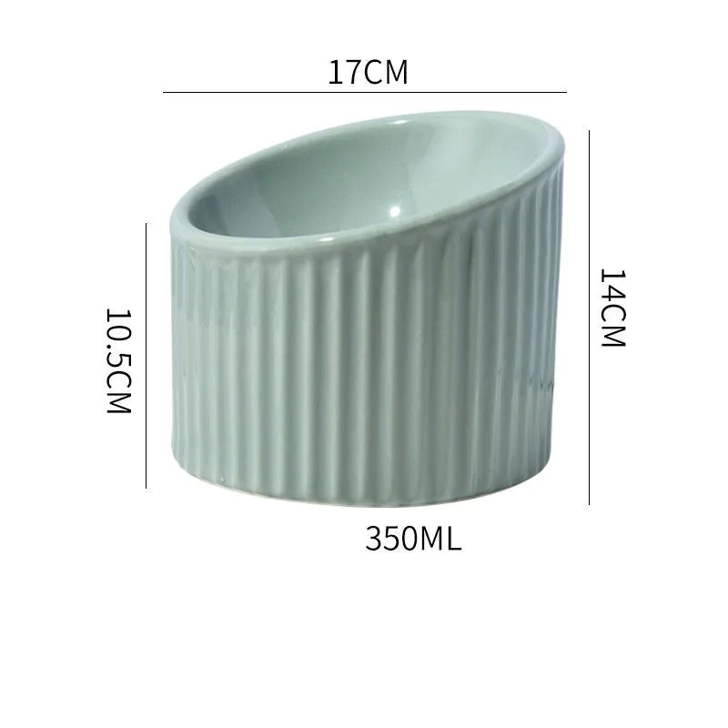 Ceramic elevated cat bowl in green, showing tilted round dish on a raised stand.