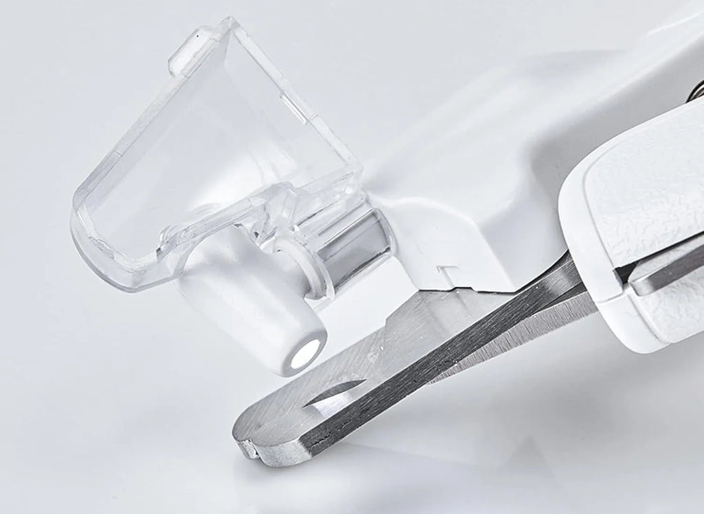 White pet nail clippers with LED light, transparent splash guard, and anti-slip handle.