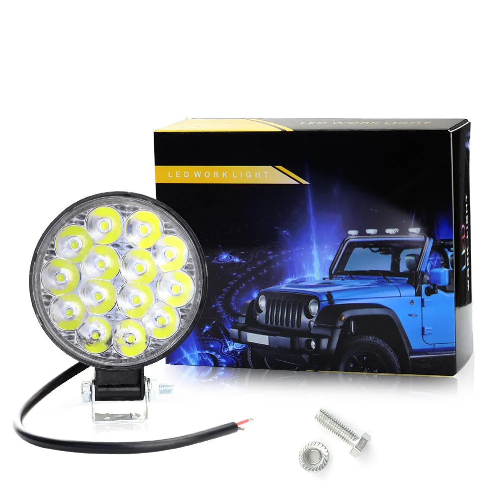 Compact round aluminium LED work light for cars and off-road vehicles with white light output.