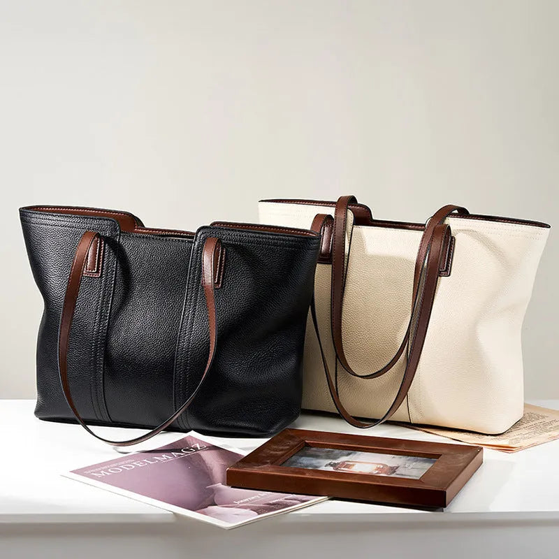 Women's black genuine leather crossbody bag showing internal compartments and horizontal square shape