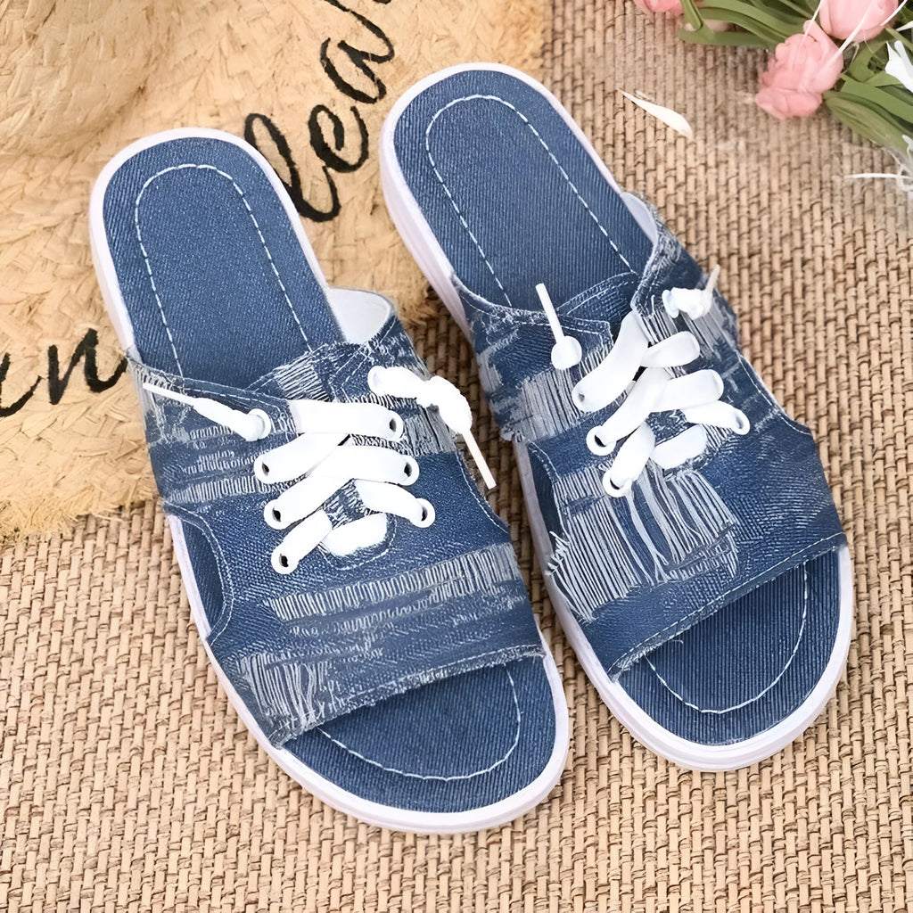 Blue Roman-style women's canvas slippers with rubber soles showing flat design and cloth upper material