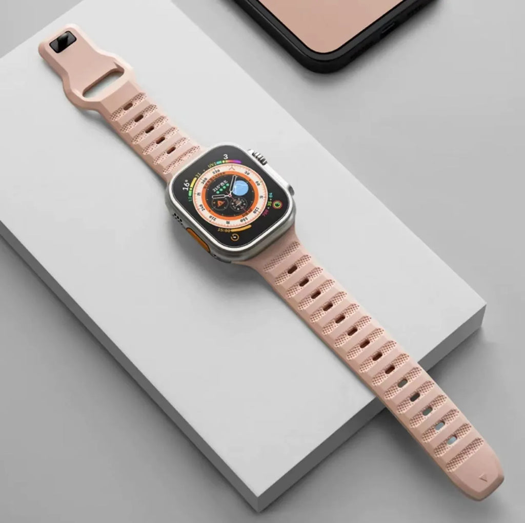 Fluoro rubber Apple Watch replacement band in multiple colours with T buckle, shown next to an Apple Watch.