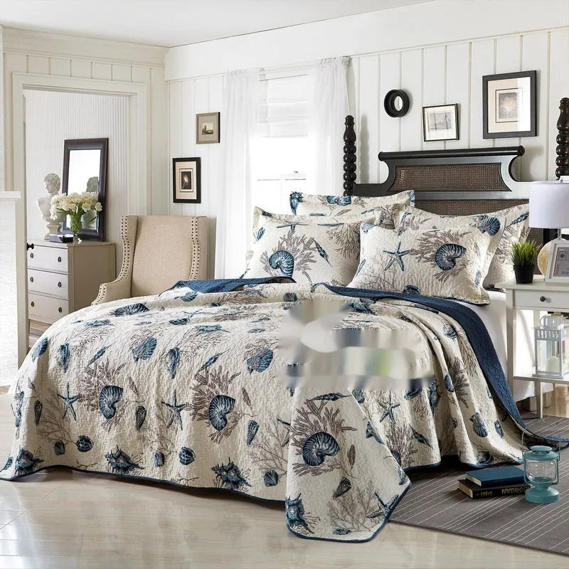 Quilted pure cotton bed cover set with printed pattern on a bed, includes two matching pillowcases.