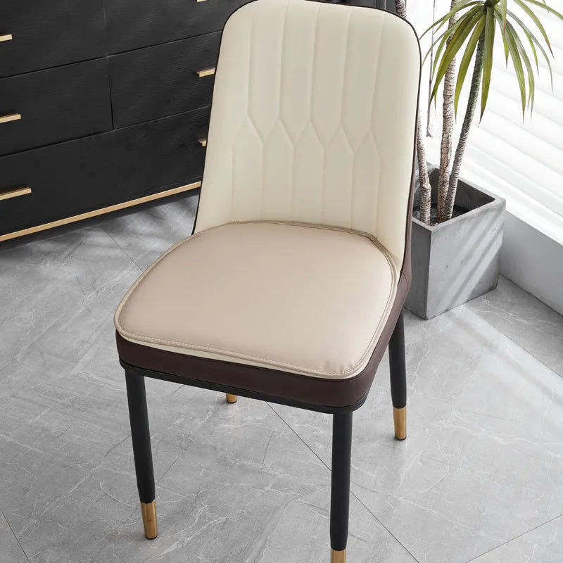 Brown leather horseshoe-shaped seat cushion with non-slip backing on a wooden chair.