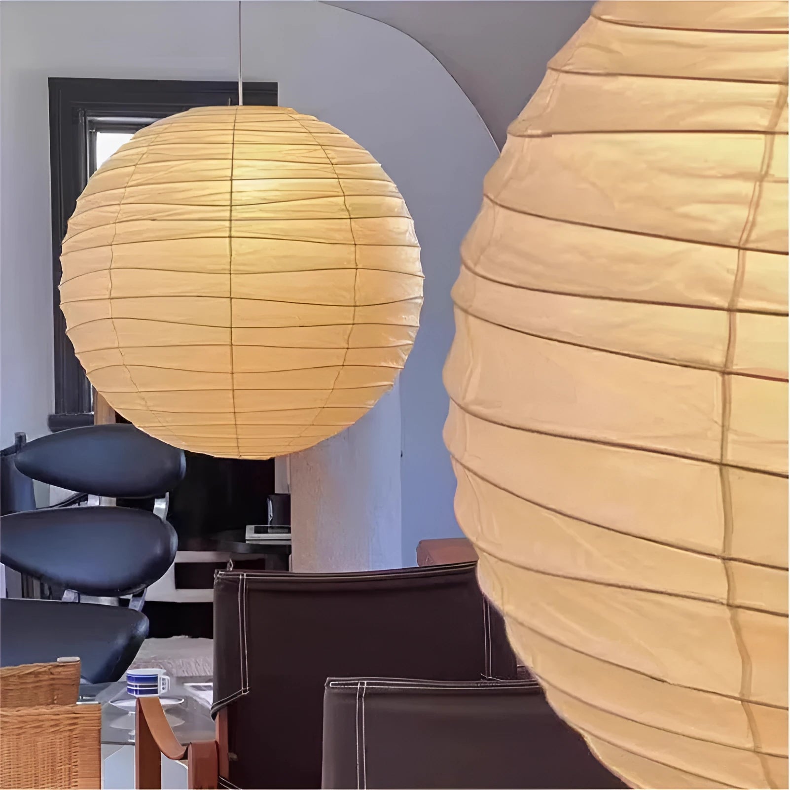 Japanese rice paper pendant chandelier with soft white shade in a living room setting.