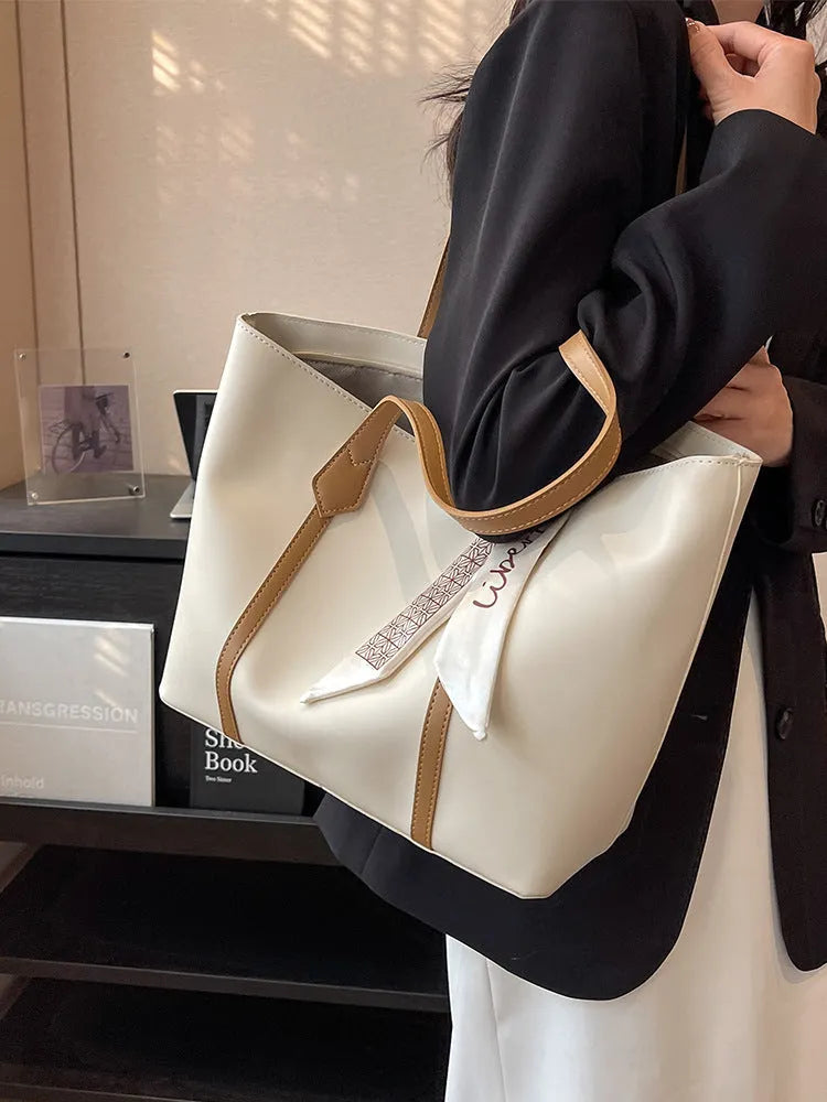 Large casual tote bag with bucket shape showing internal zippered pocket and sewing line detailing