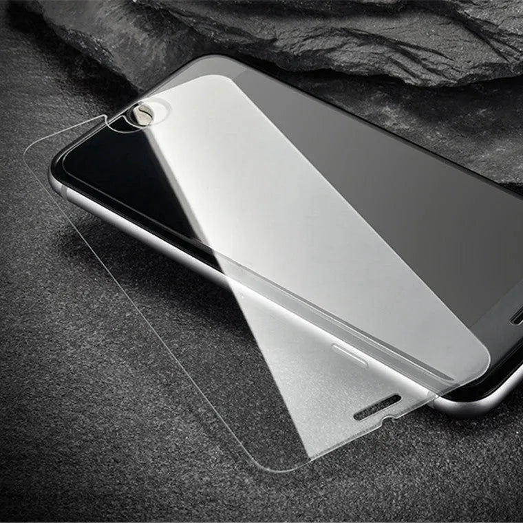 Tempered glass screen protector with 9H hardness for smartphones on a clean surface.