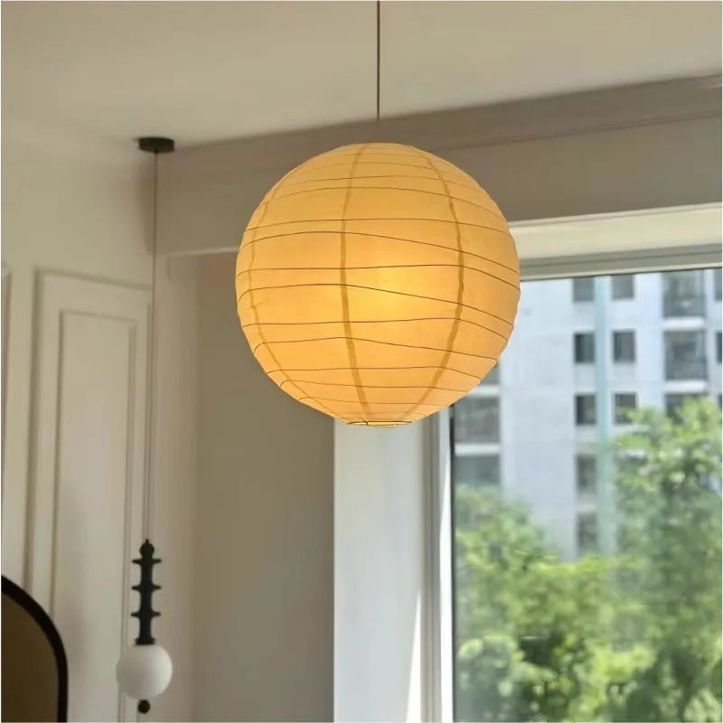 Japanese rice paper pendant chandelier with soft white shade in a living room setting.