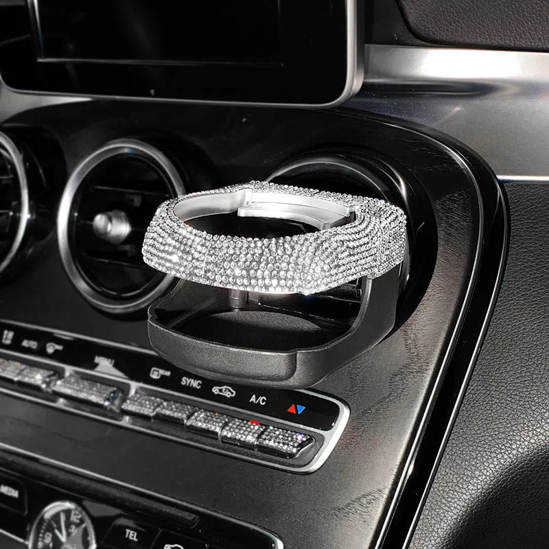 White diamond-encrusted ABS plastic car cup holder bracket mounted on a car air vent.