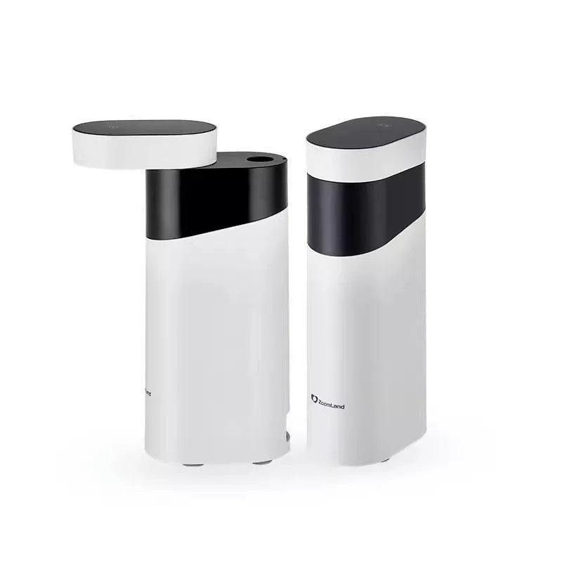 Small black portable instant water dispenser or travel kettle on a desktop.