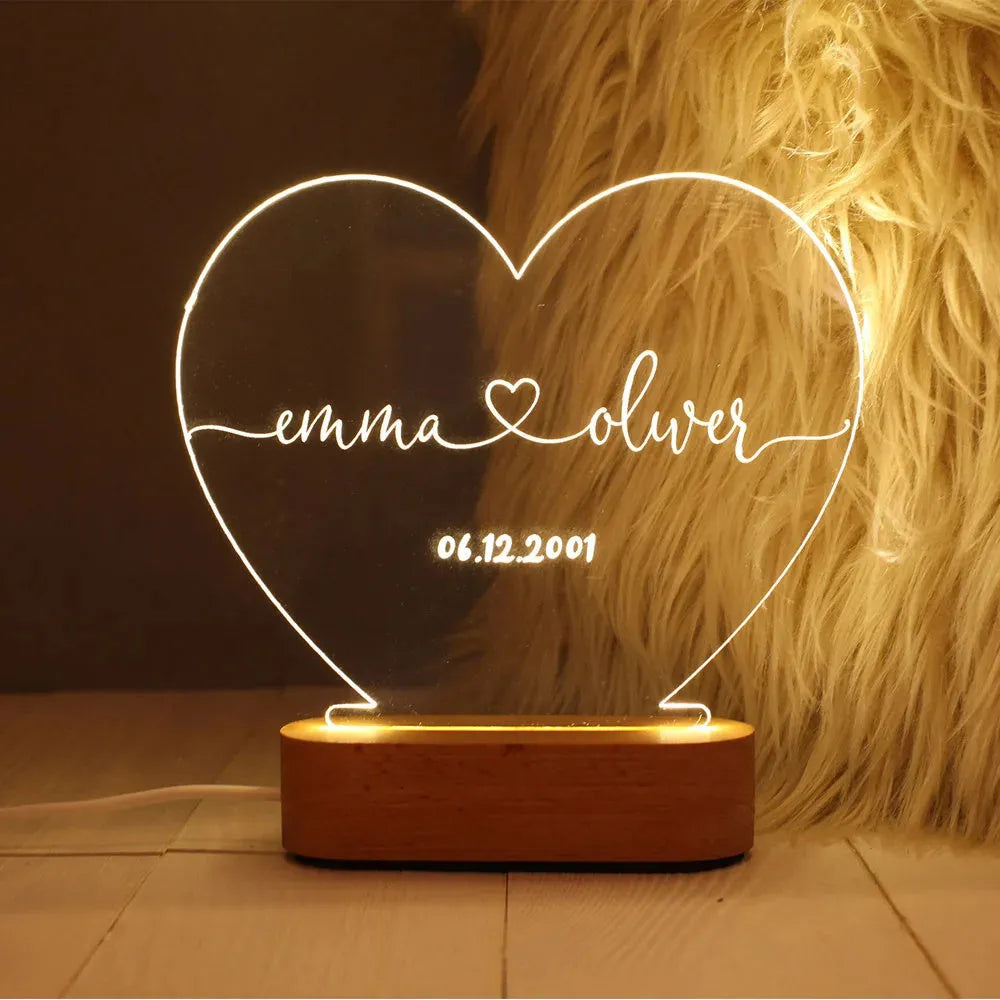 Custom engraved acrylic night light with LED base, showing personalised names and date.