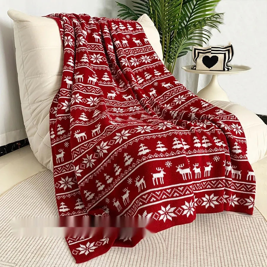 Personalised Christmas acrylic blanket with reindeer or snowflake pattern on a sofa