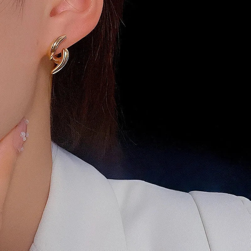 Pair of geometric copper stud earrings with textured line design and electroplated finish
