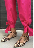 Leopard print women's pumps with cross shoulder straps and a chunky low heel