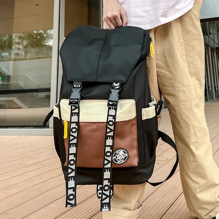 Oxford cloth backpack in black, green, or red with handheld grip and shoulder straps.