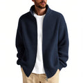 Man wearing a loose grey men's cardigan sweater, a casual acrylic knitwear piece for leisure.