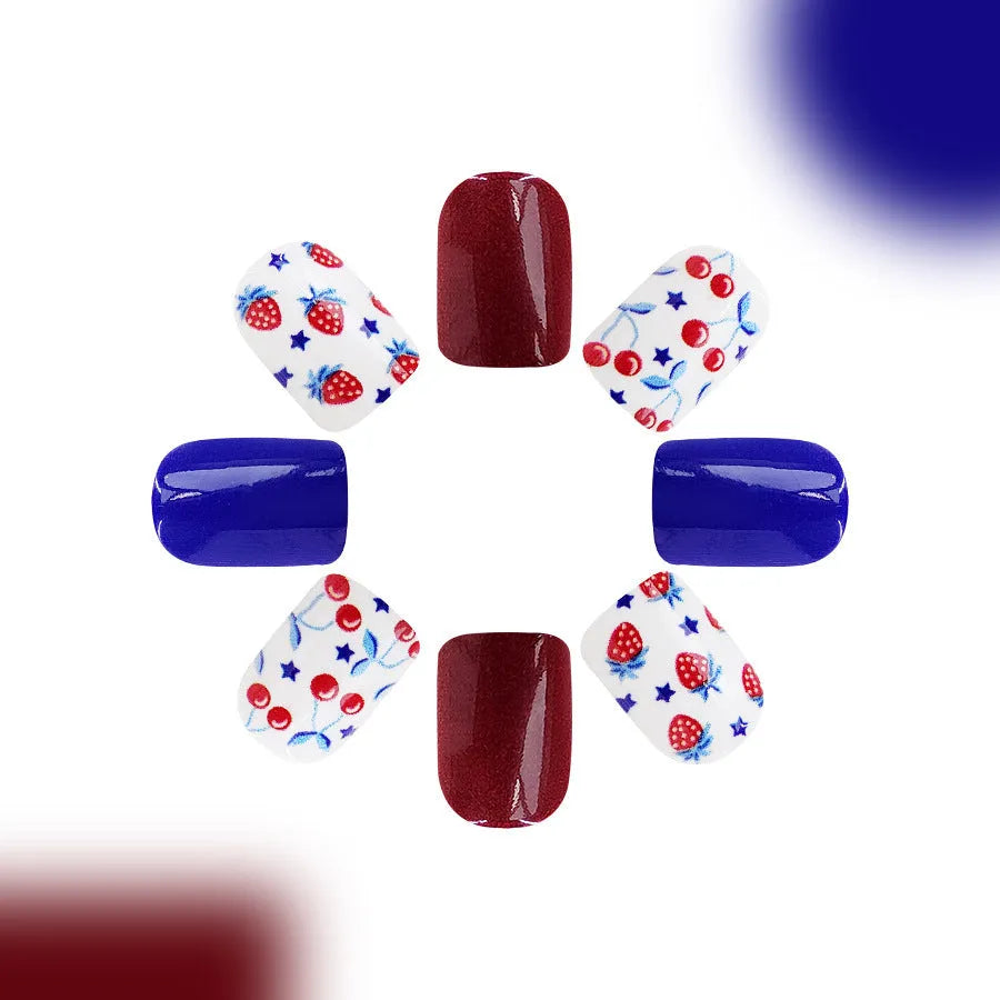 Short glossy false nails with red and blue strawberry and cherry Independence Day design