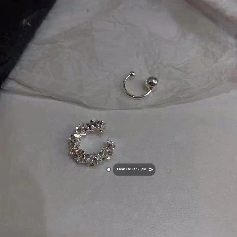 A pair of silver geometric irregular-shaped earrings with a frosted finish and clip-on fastenings.