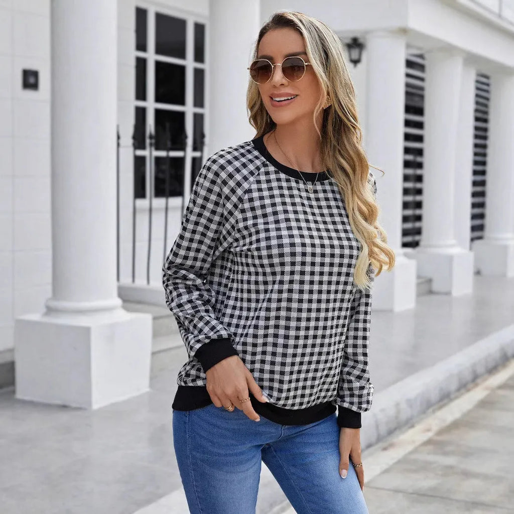 Black long sleeve pullover sweater with printed plaid and stripe pattern.