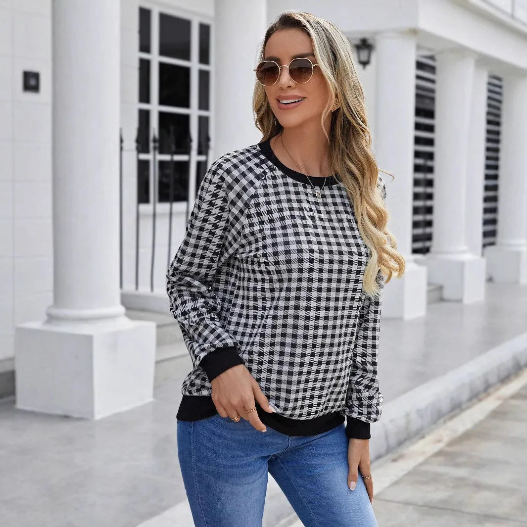 Black long sleeve pullover sweater with printed plaid and stripe pattern.