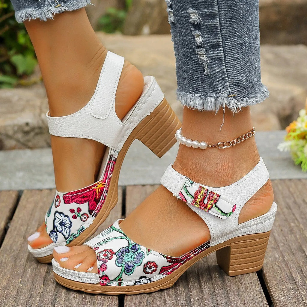 White women's high heel sandals with a Velcro buckle strap and a rubber sole.