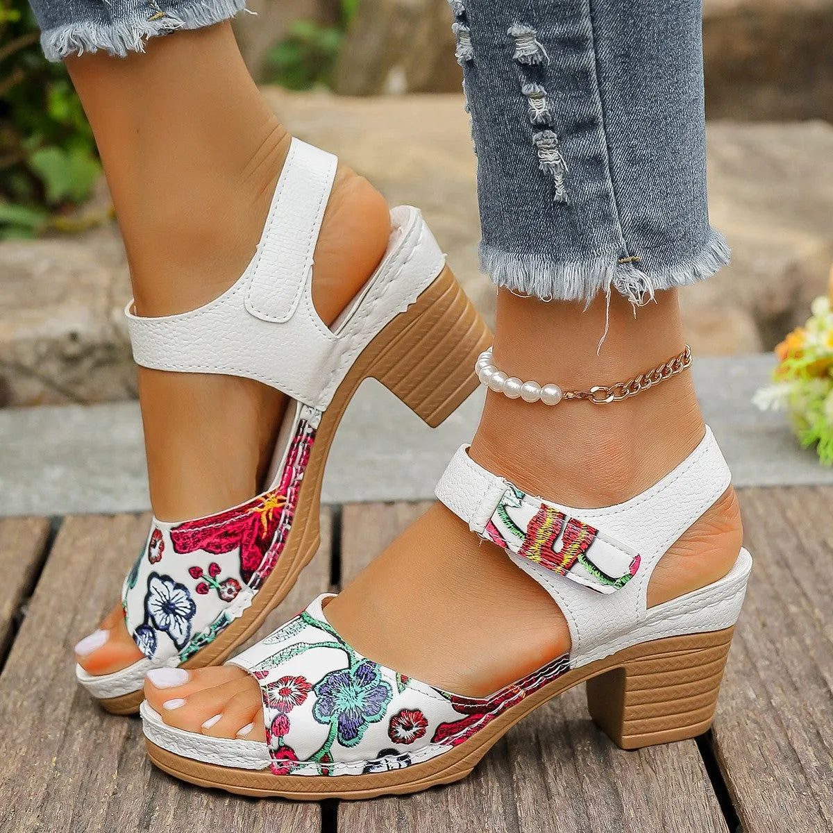 White women's high heel sandals with a Velcro buckle strap and a rubber sole.