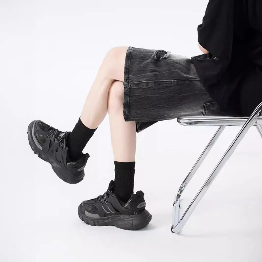 Men's loose-fit washed ripped denim shorts in black and blue colours with distressed detailing and retro styling