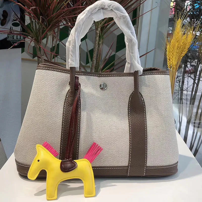 Genuine leather crossbody bucket tote bag with canvas surface in multiple colour options