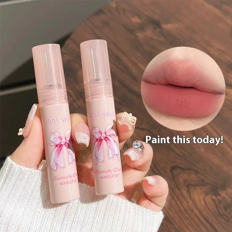 Butterfly Box cosmetics set showing four matte lip muds, pink powder blusher and necklace