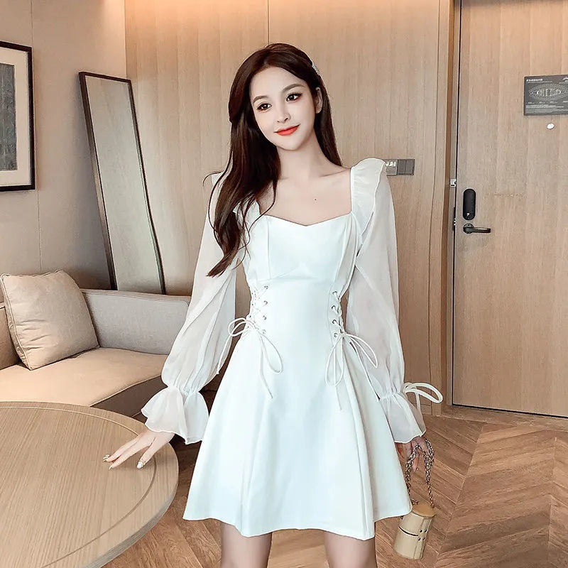 White chiffon patchwork dress with long sleeves, long skirt, and a waist-slimming design on a mannequin.