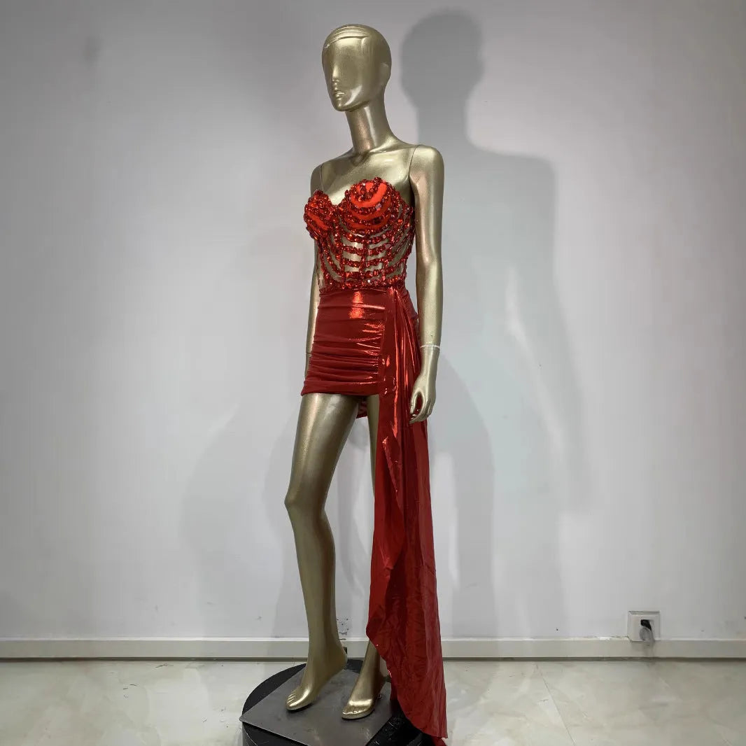Red women's skirt suit with see-through mesh panels, made from stretch spandex fabric.