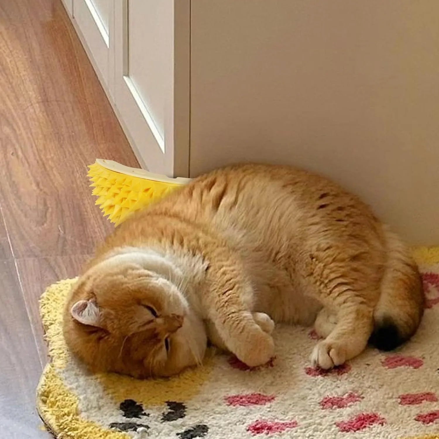 Yellow durian-shaped cat corner massage comb scratcher mounted on a wall.