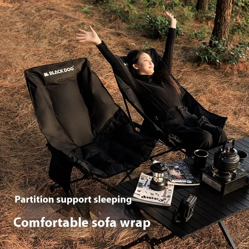 Night Black portable folding moon chair in use outdoors, showing its reclined design and carry handle.
