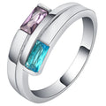 Copper ring with silver electroplated finish and inset zircon detail on a finger.