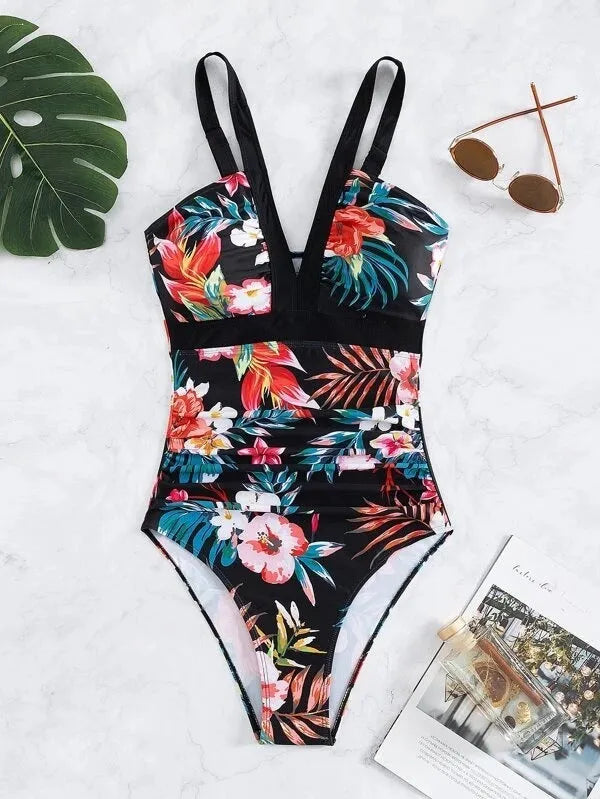 Women's black floral backless one-piece swimsuit on a mannequin