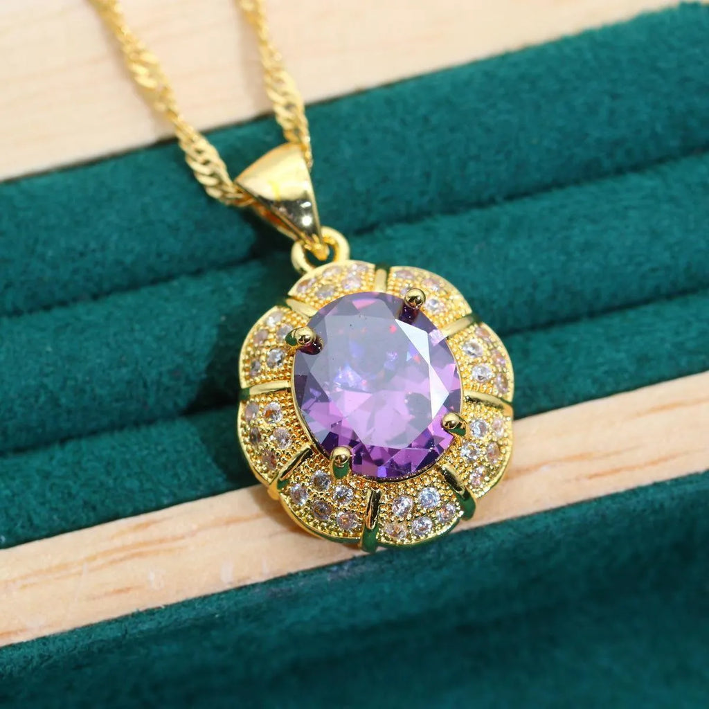 Gold-plated necklace, earrings, ring and bracelet set with blue cubic zirconia stones.