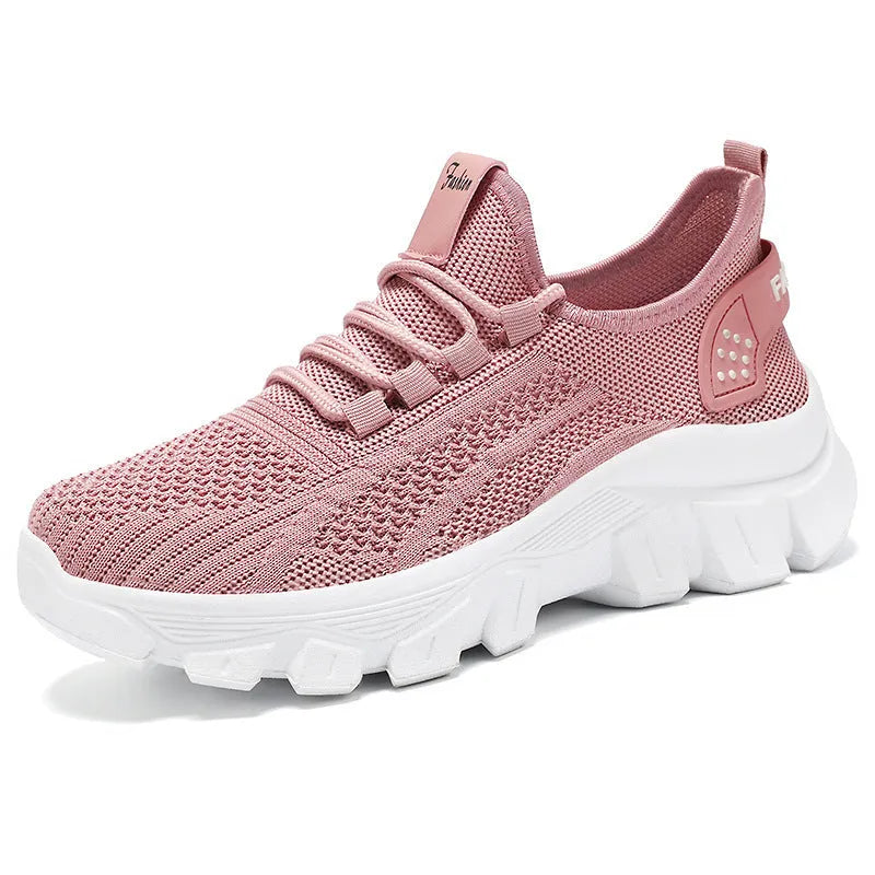 Women's white Flyknit sneakers with a thick PVC sole and front lace-up on a plain background.