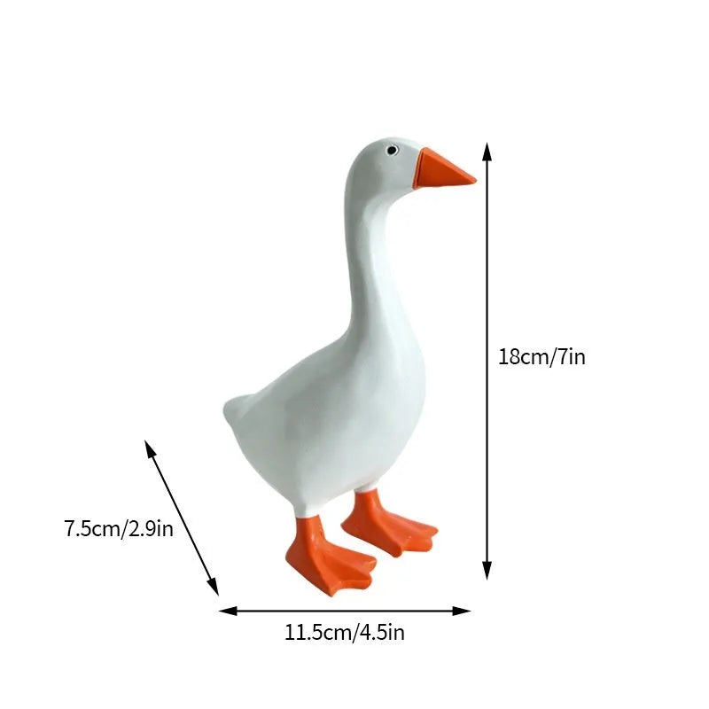 White simulation duck resin magnetic ornament on metal surface holding a note