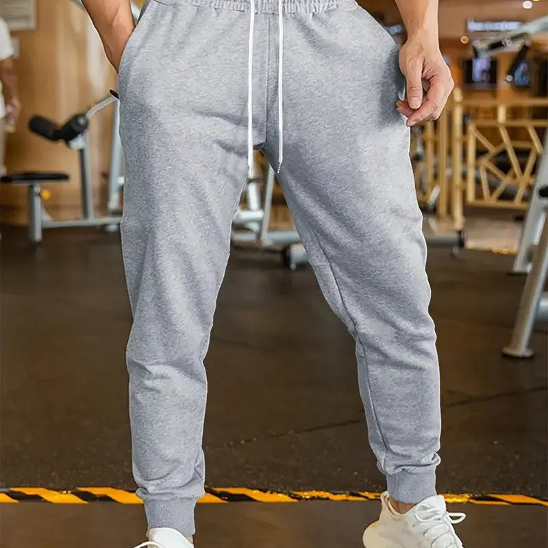 Men's polyester leisure trousers with elastic lace closure and drawstring waist in loose fit design