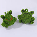 Handmade woven green plush frog car pendant hanging from a rear-view mirror.