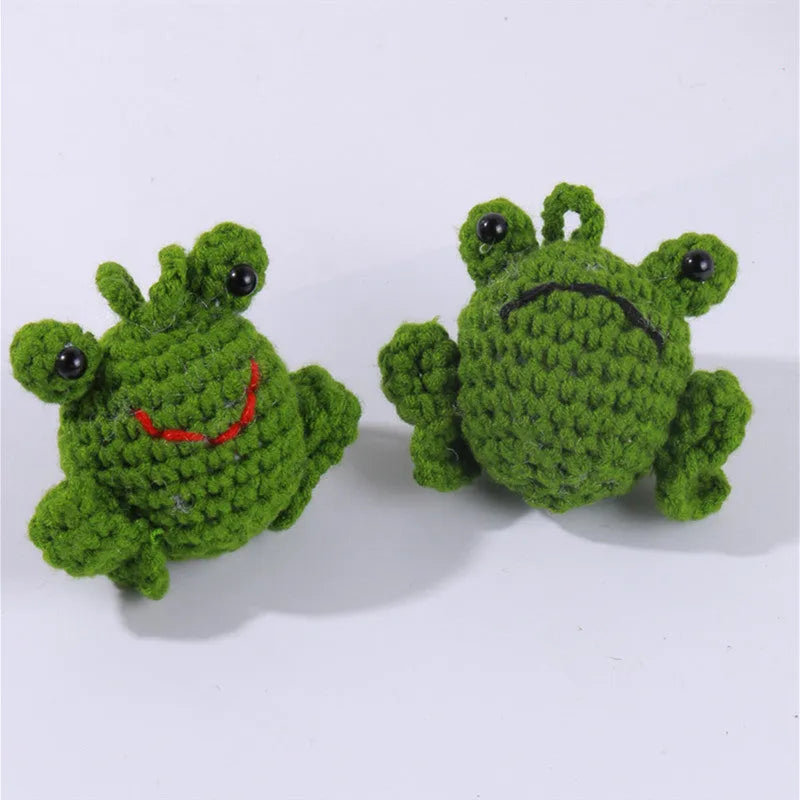 Handmade woven green plush frog car pendant hanging from a rear-view mirror.