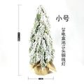 24 inch plastic Christmas tree with lights and PE snow decoration on desktop