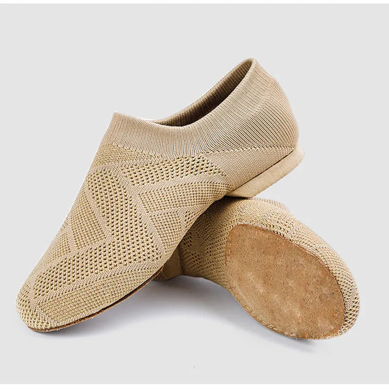 Camel colour dance yoga shoes with cotton mesh upper and leather sole on a plain background.