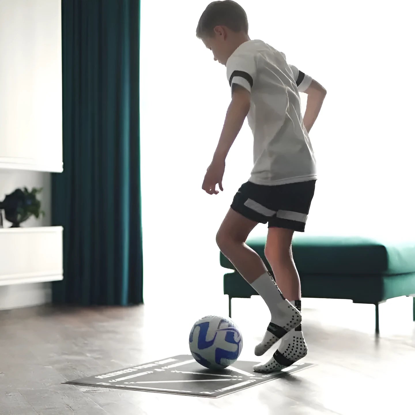 Black rectangular 60x90cm football training mat with a non-slip rubber base.