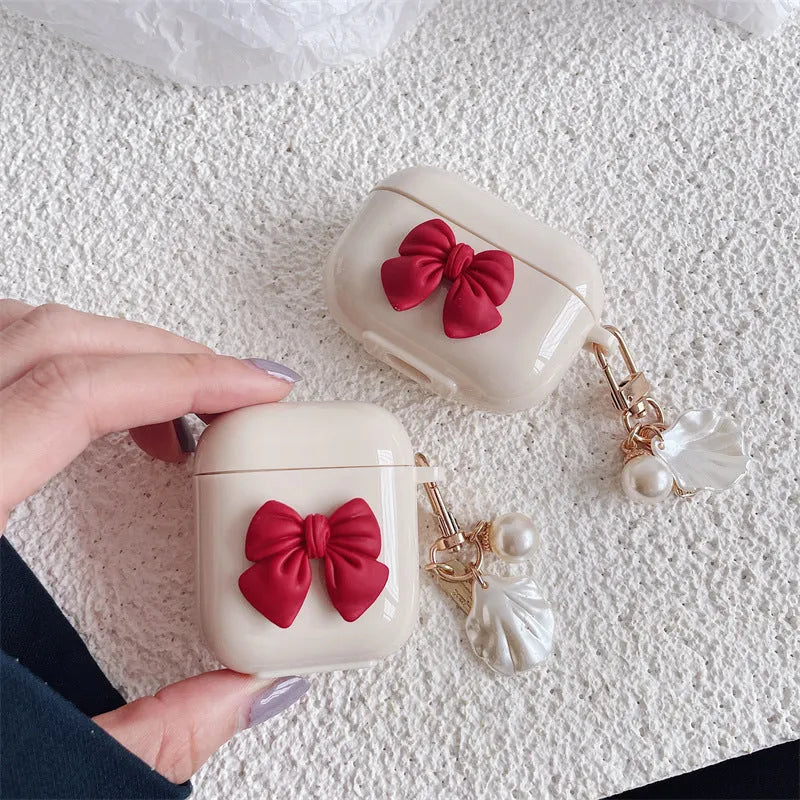 Beige and red bow shell design TPU silicone protective case for AirPods Pro charging case.