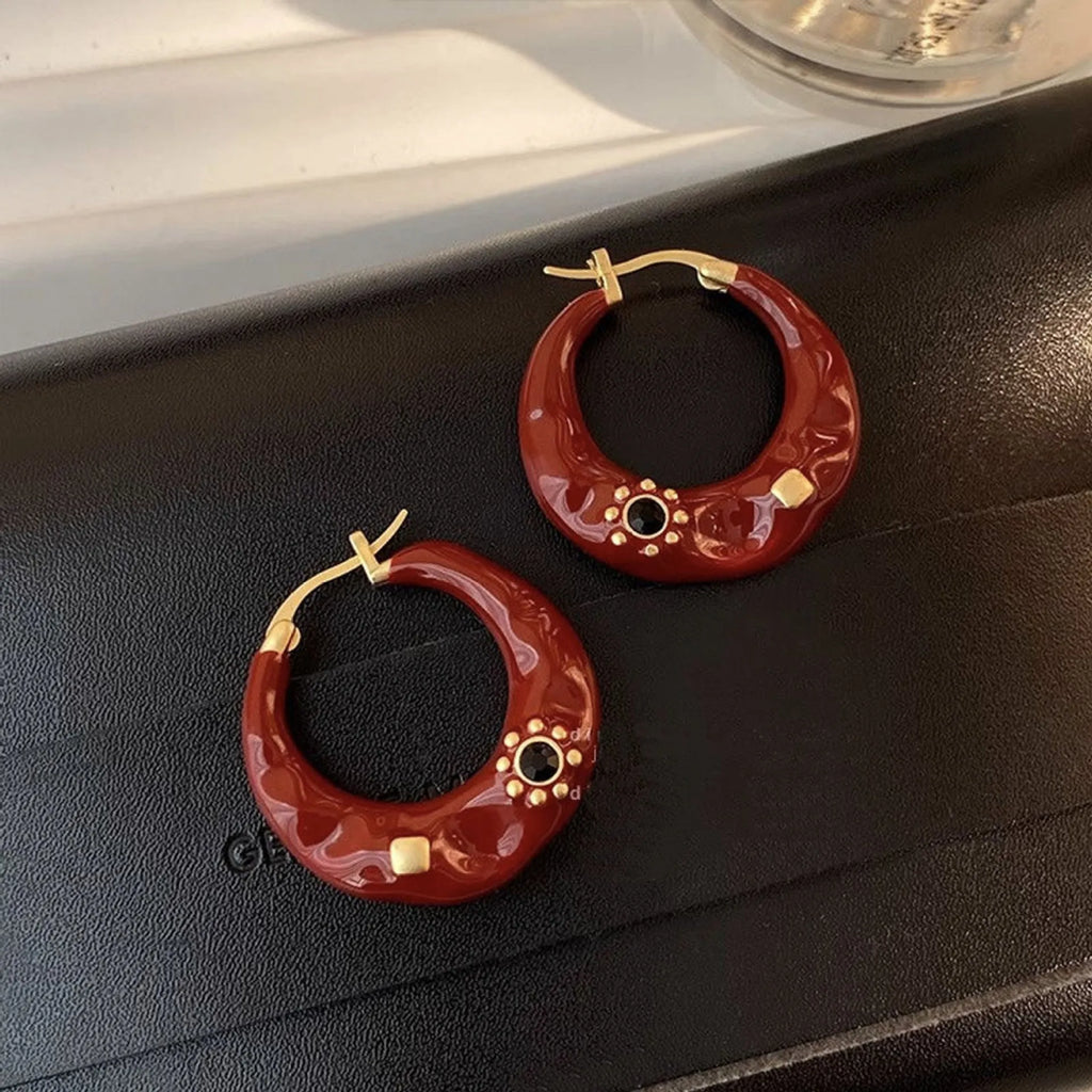 Hong Kong style retro ear studs with dripping oil finish and rhinestone detail in black and red colours