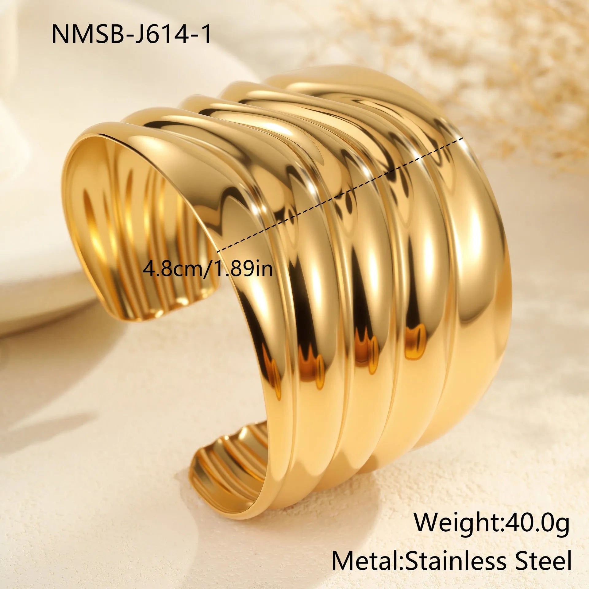 Women's wide cuff bracelet with gold plating and exaggerated niche opening in asymmetric wave design