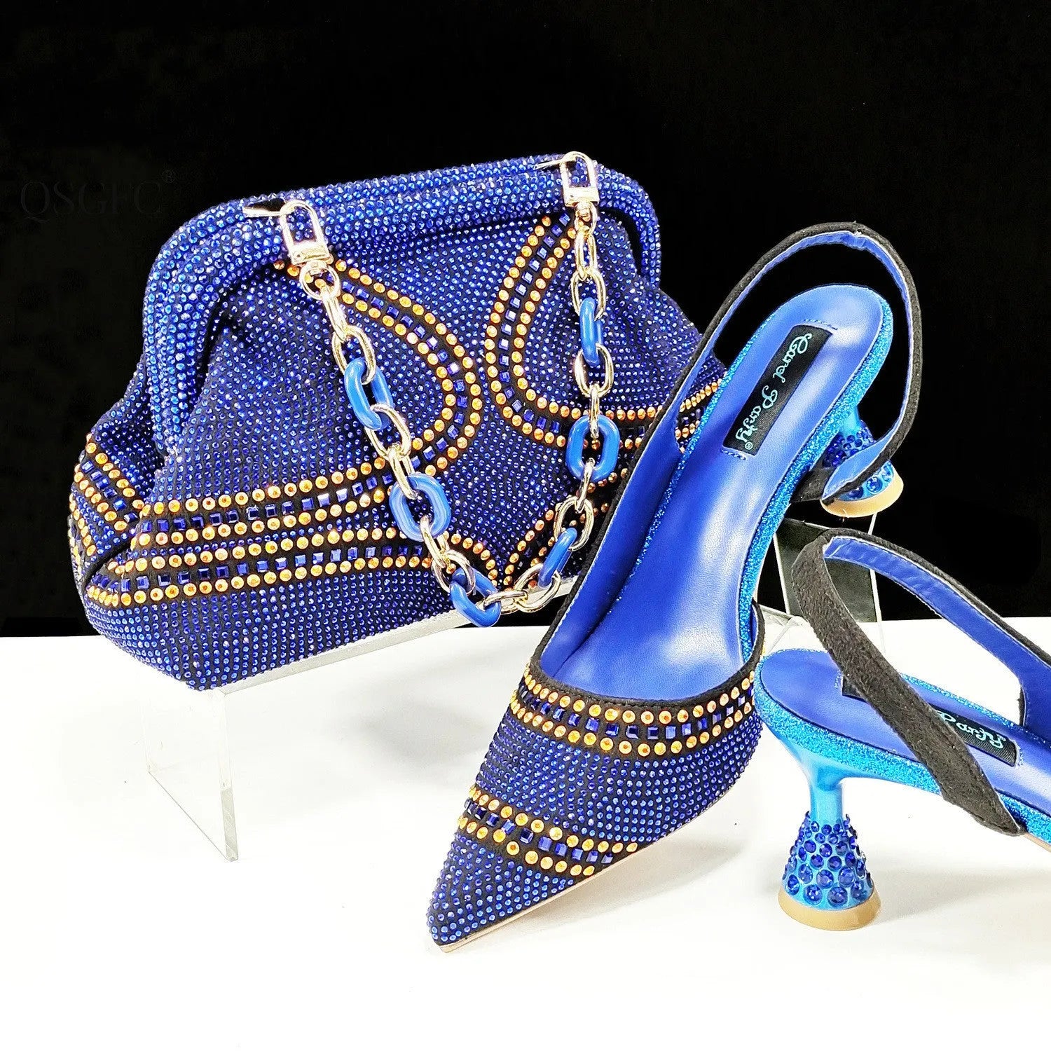 Women's pink pointed toe high heel shoes with rhinestones and a matching small clutch bag.