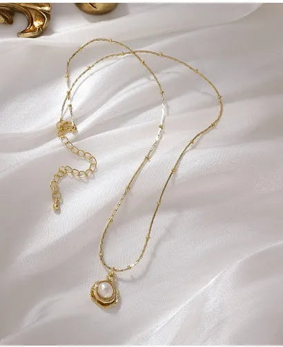 Baroque freshwater pearl necklace with titanium steel golden chain on display