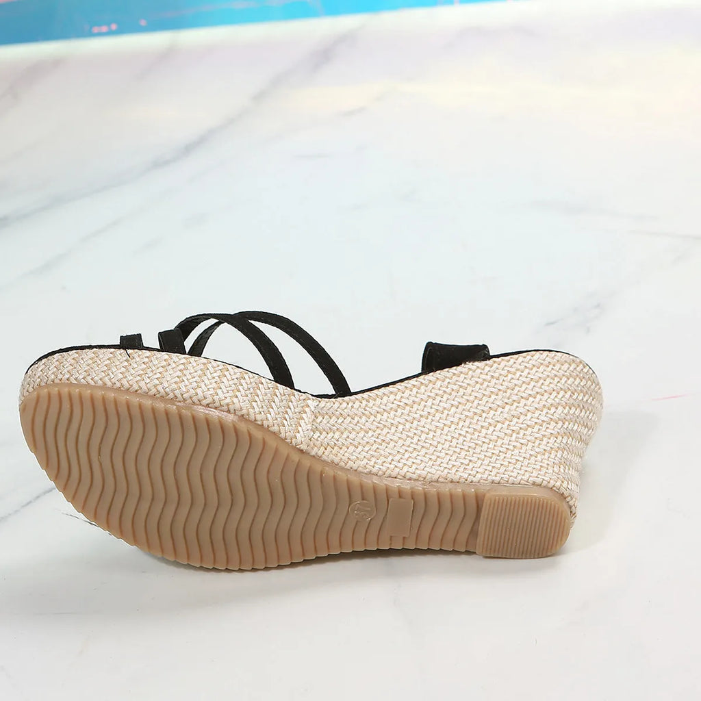 Women's beige cloth wedge sandals with a fish mouth toe design on a plain background.